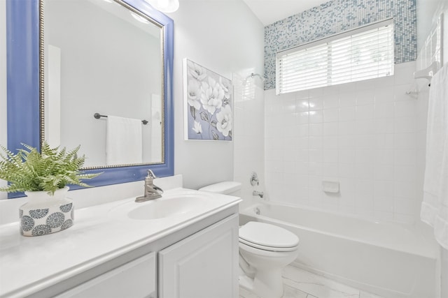 full bathroom featuring toilet, tiled shower / bath, and vanity