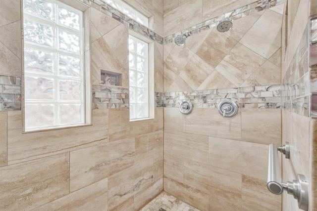 bathroom with tiled shower