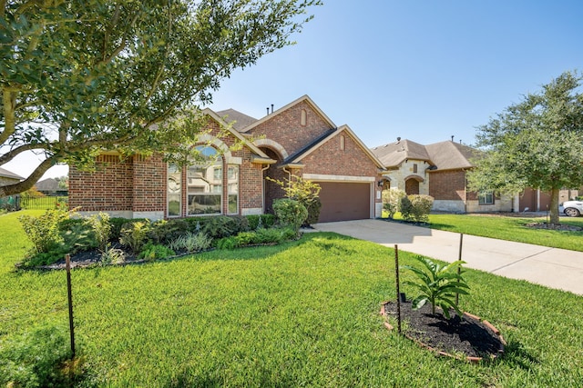 view of front of property with a garage and a front yard