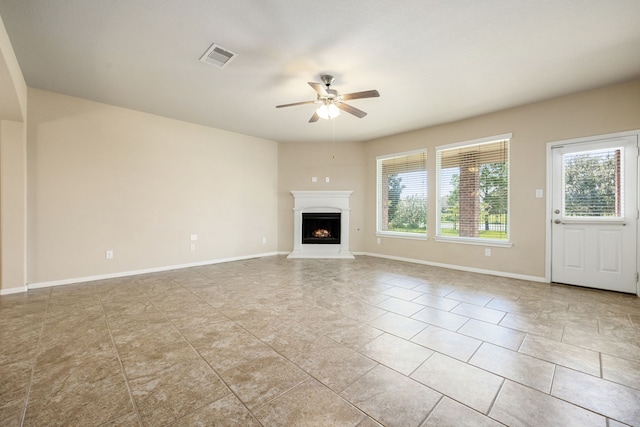 unfurnished living room with light tile patterned flooring and ceiling fan