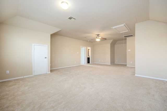 unfurnished room with light colored carpet, ceiling fan, and vaulted ceiling