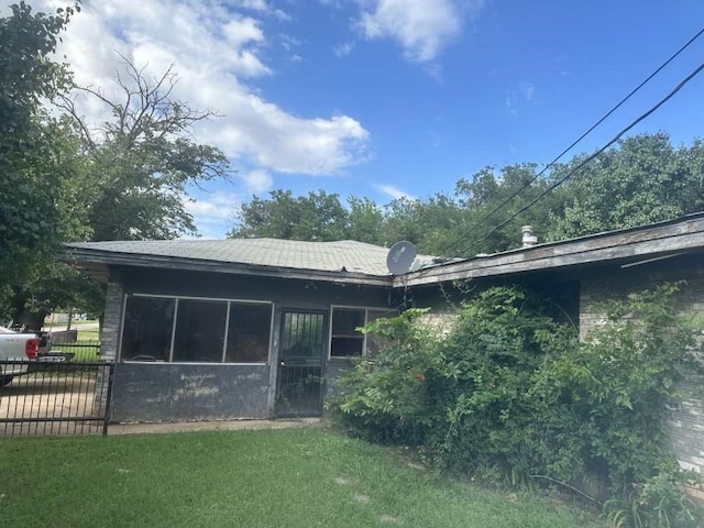 rear view of house featuring a lawn