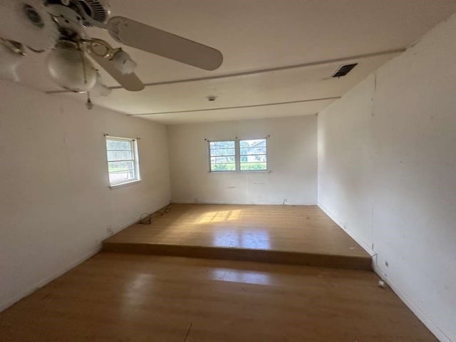 spare room with ceiling fan and hardwood / wood-style flooring