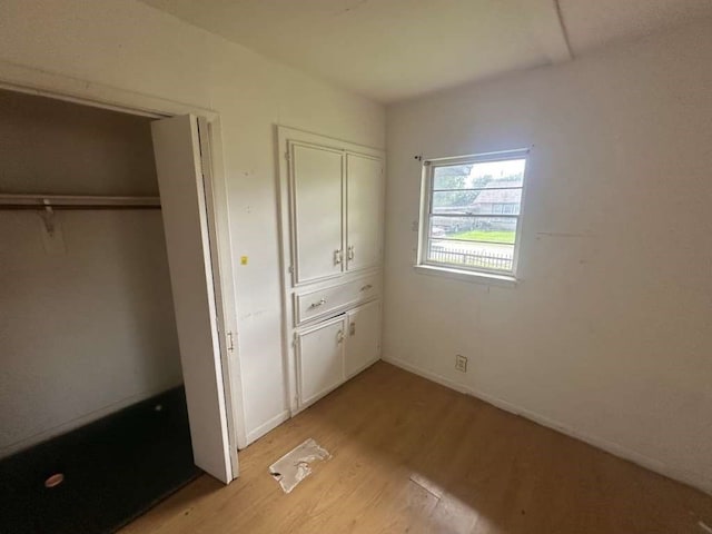 unfurnished bedroom featuring light wood-type flooring