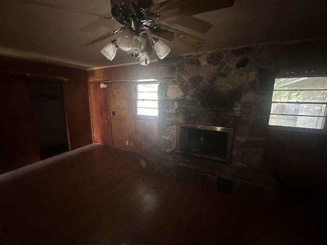 unfurnished living room with ceiling fan, hardwood / wood-style flooring, and a fireplace