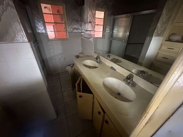 bathroom featuring vanity, toilet, and tile walls