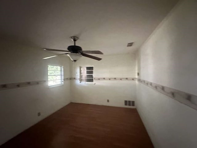 empty room with wood-type flooring and ceiling fan