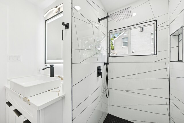 bathroom featuring vanity and a tile shower