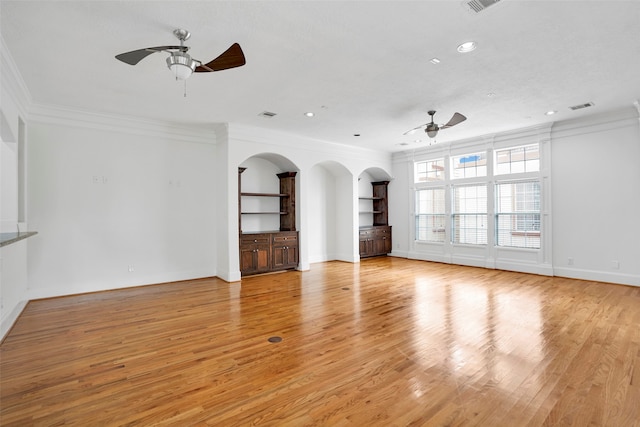 unfurnished living room featuring crown molding, ceiling fan, and light hardwood / wood-style floors