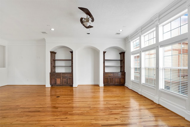 spare room with ornamental molding, light hardwood / wood-style flooring, and ceiling fan