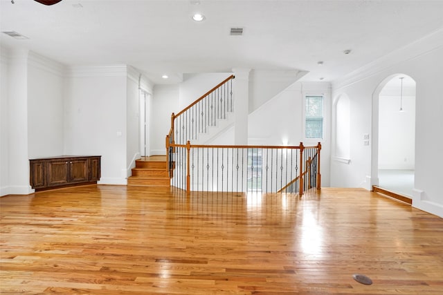 unfurnished room with ornamental molding and light hardwood / wood-style flooring