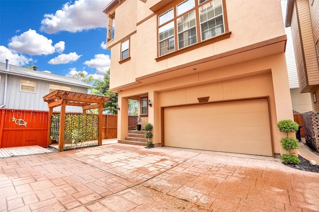 exterior space with a garage and a pergola