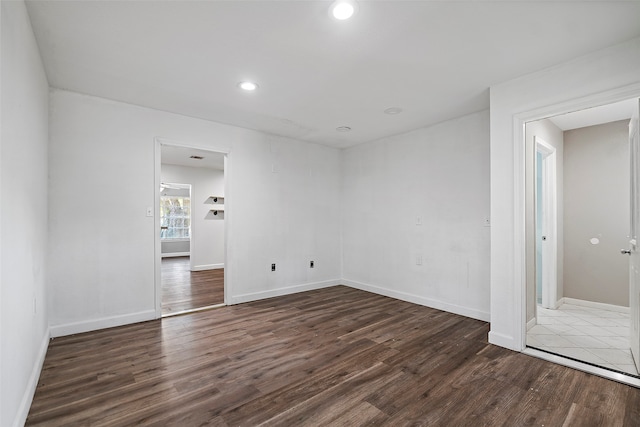 spare room with dark wood-type flooring