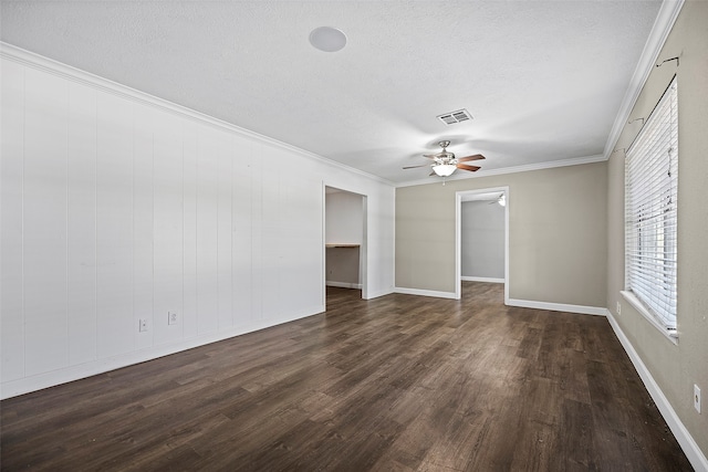 spare room featuring a textured ceiling, dark wood-type flooring, ceiling fan, and ornamental molding