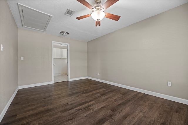 spare room featuring ceiling fan and dark hardwood / wood-style flooring