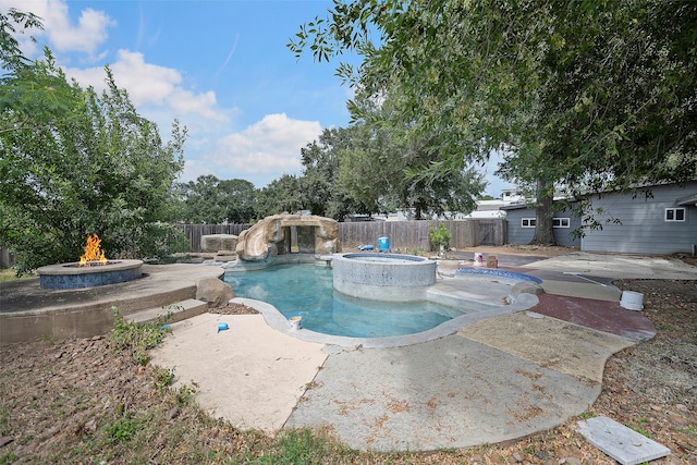 view of pool with an outdoor fire pit, an in ground hot tub, and a patio