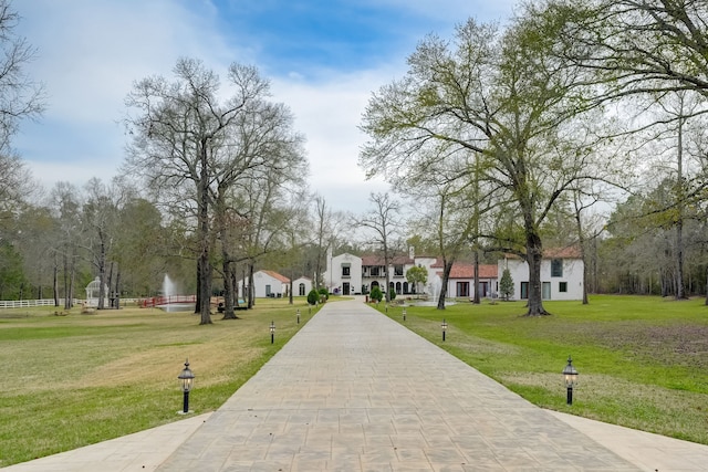 view of property's community with a yard