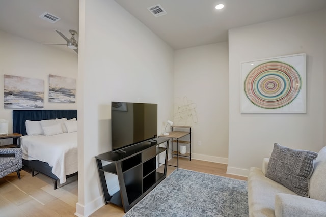 living room featuring light wood-type flooring and ceiling fan