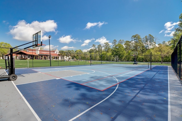 view of basketball court with a lawn and tennis court