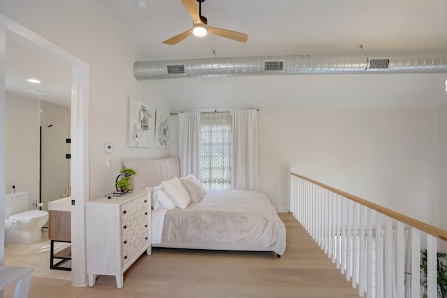 bedroom featuring ceiling fan, light wood-type flooring, and vaulted ceiling