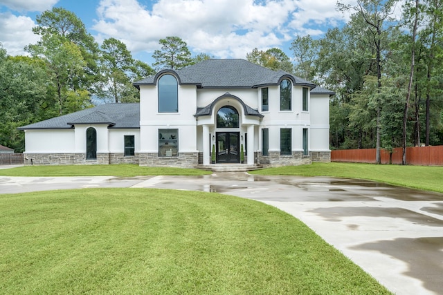 french country home featuring a front yard