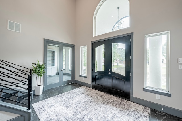 entryway featuring french doors and a high ceiling