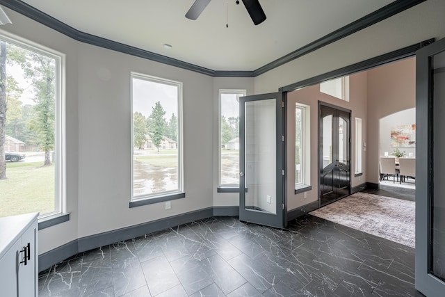 doorway with ornamental molding, a wealth of natural light, and ceiling fan