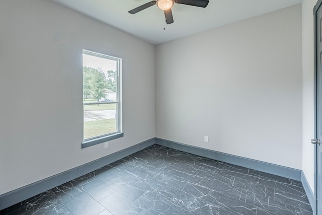 spare room with a healthy amount of sunlight and ceiling fan