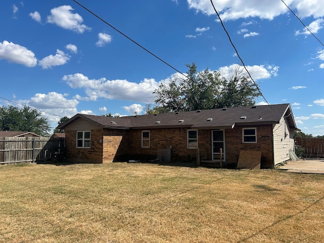 back of property featuring a yard