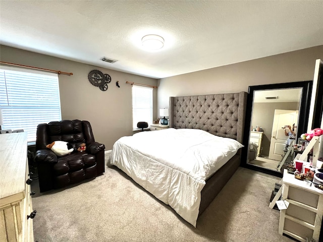 carpeted bedroom with a textured ceiling