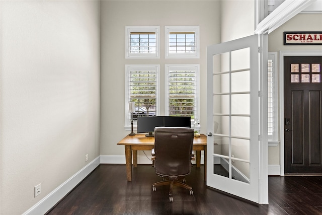 office area with a high ceiling and dark hardwood / wood-style flooring