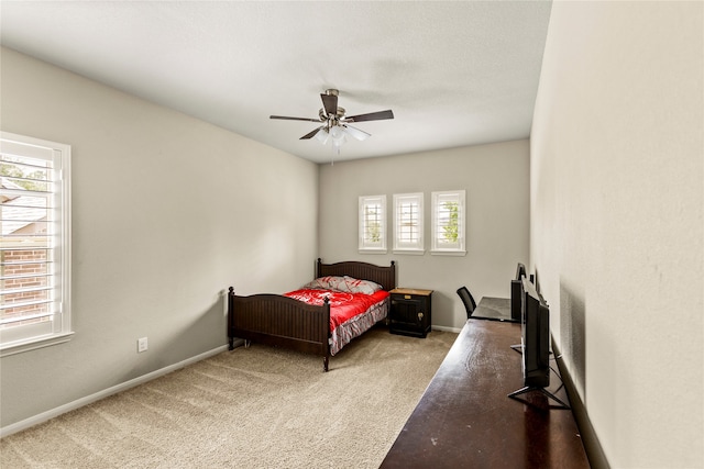 bedroom featuring carpet, ceiling fan, and multiple windows