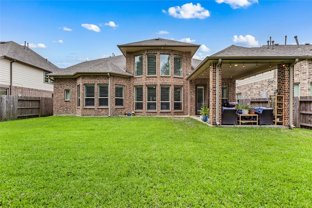 rear view of house featuring an outdoor hangout area, a yard, and a patio