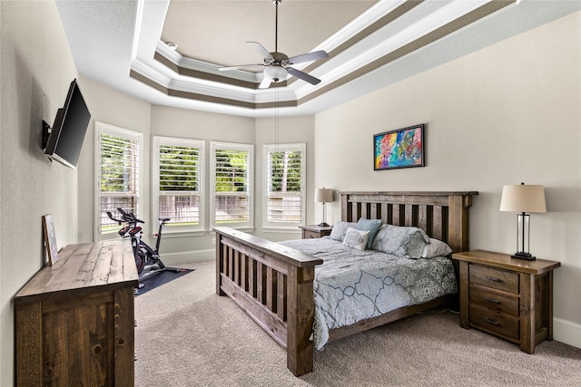 bedroom featuring crown molding, light colored carpet, ceiling fan, and a raised ceiling