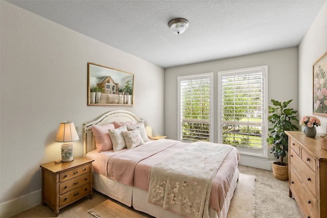 carpeted bedroom featuring a textured ceiling