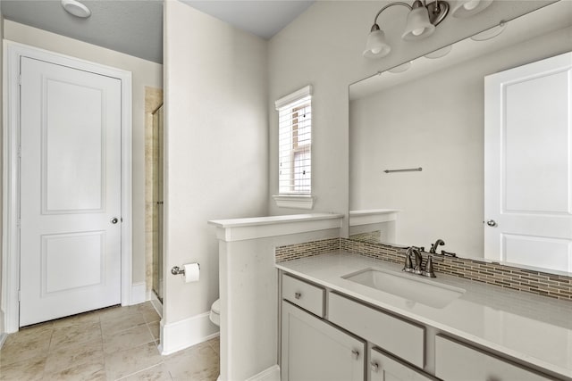 bathroom featuring vanity, toilet, walk in shower, and tile patterned flooring