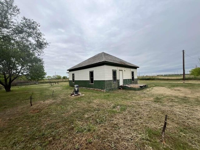 300 E Curtis St, Quanah, TX 79252 - view of home's exterior featuring a lawn