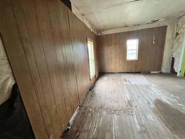 300 E Curtis St, Quanah, TX 79252 - spare room featuring light wood-type flooring and wooden walls