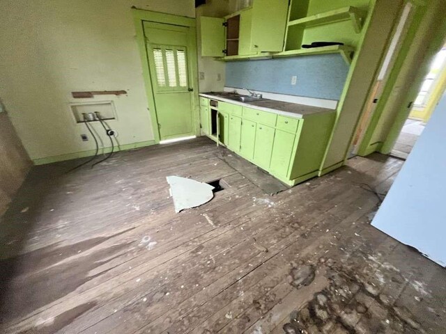 300 E Curtis St, Quanah, TX 79252 - kitchen featuring green cabinets, yellow cabinets, wood-type flooring, and a sink