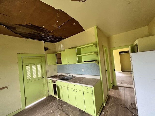 300 E Curtis St, Quanah, TX 79252 - kitchen with open shelves, a sink, dark wood-type flooring, and green cabinetry