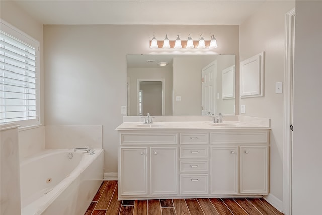 bathroom with vanity, wood-type flooring, and a washtub