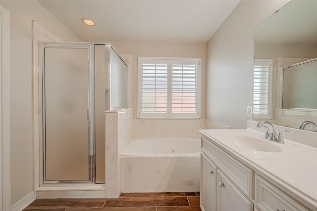 8705 Rowen Ct, Needville, TX 77461 - bathroom featuring a tub with jets, a stall shower, wood finished floors, and vanity