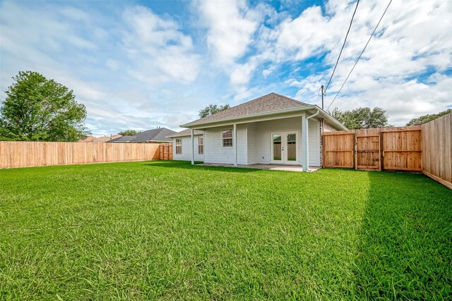 8705 Rowen Ct, Needville, TX 77461 - rear view of property with a yard, a shingled roof, french doors, and a fenced backyard