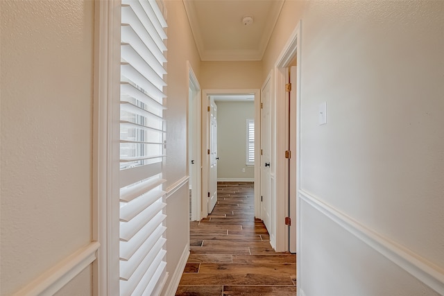 hall with ornamental molding and light wood-type flooring