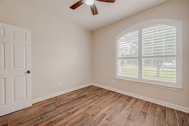 spare room with hardwood / wood-style floors and ceiling fan