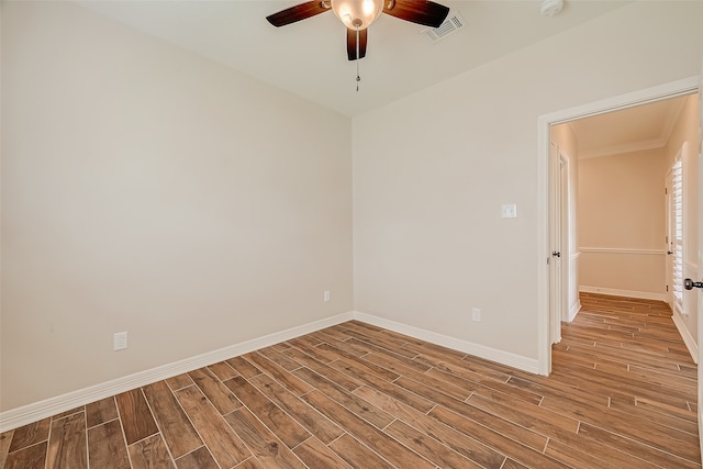 empty room with ceiling fan and light hardwood / wood-style floors