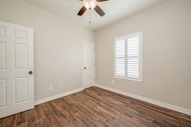 unfurnished room with ceiling fan and dark hardwood / wood-style flooring