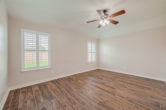 spare room featuring a healthy amount of sunlight, ceiling fan, and hardwood / wood-style flooring