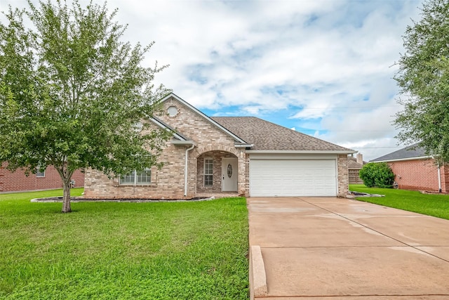 8705 Rowen Ct, Needville, TX 77461 - view of front of home with a front yard, a garage, concrete driveway, and brick siding