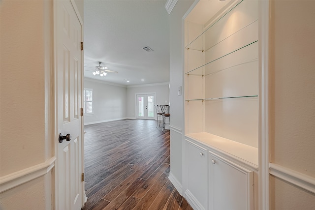 corridor with crown molding, dark wood-type flooring, and french doors